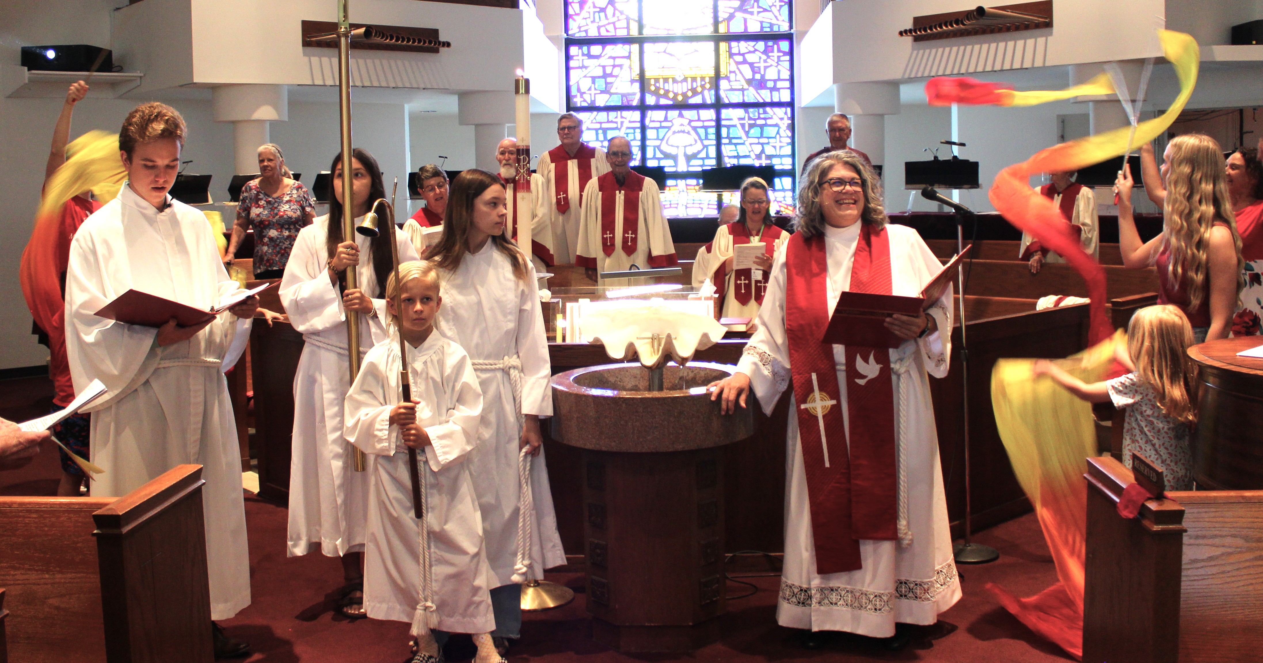 A baptism at the font during Sunday worship